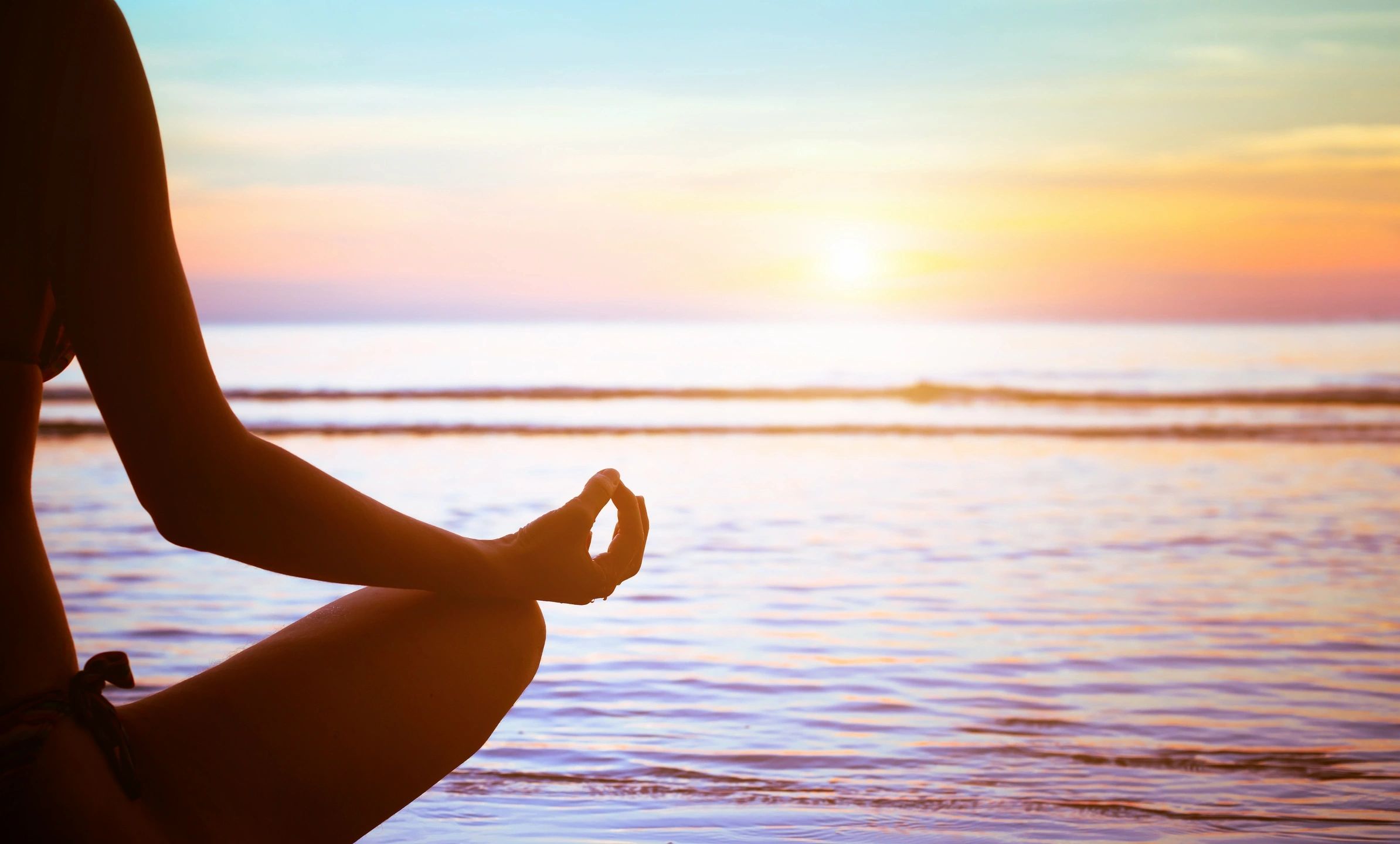 The Impact of Preconception Stress on Pregnancy woman meditating by the water